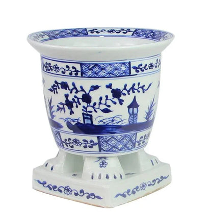 Jardinière sur pied bleu foncé et blanche avec motif de scène de village